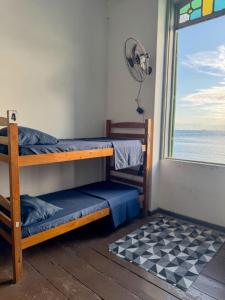 a room with bunk beds in a room with a window at Caminito Salvador Hostel in Salvador