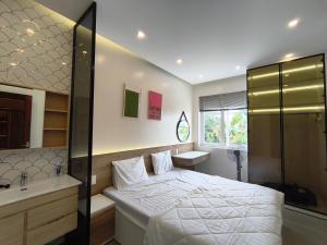 a bedroom with a bed and a sink and a shower at Villa ATH Nova Word Phan Thiết in Bình Tú +18 photos
