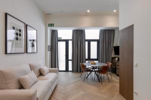 a living room with a couch and a table at Boutique Room - One Tower in Valencia