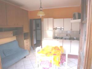 a kitchen with a table in the middle of a room at Agriturismo La Bordiga in Paesana +12 photos
