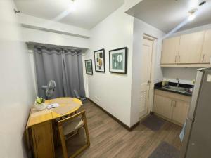 a small kitchen with a table and a table and a sink at LaVerti 1BR Affordable staycation groups family in Manila