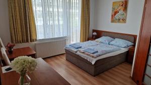 a bedroom with a bed with blue pillows on it at Giselle in Mielno