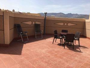 a patio with chairs and a table on a roof at Passo Nador 3 chambres in Nador