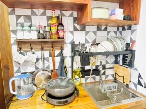 a kitchen counter top with a sink and a stove at 307MSNK Luxe Studio l Balcony & Kitchen in Can Tho