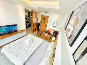 a living room with a bed and a tv at 307MSNK Luxe Studio l Balcony & Kitchen in Can Tho