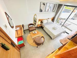 an overhead view of a living room with a bed and a table at 307MSNK Luxe Studio l Balcony & Kitchen in Can Tho +15 photos
