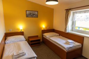 Cama ou camas em um quarto em Hotel Zámeček