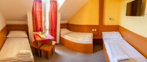 Cama ou camas em um quarto em Hotel Zámeček