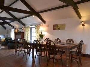 a dining room with a wooden table and chairs at The Old Granary in Kilkhampton