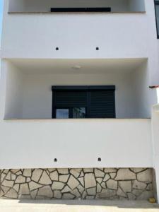 a mirror on the side of a building with a window at Guesthouse Dreamscape city Krk in Krk