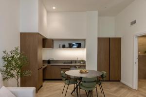 a kitchen and living room with a table and chairs at Boutique Room - One Tower in Valencia