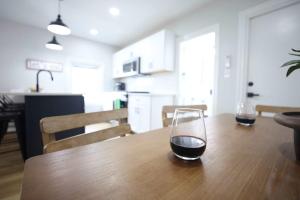 two glasses of wine sitting on a wooden table at Jennifer's Elegant & Cozy Broadway Retreat in Providence +22 photos
