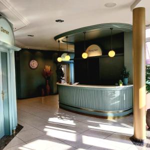 a lobby with a counter in a building at Auehof Hotel & Restaurant in Garrel