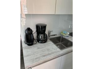 a kitchen counter with a coffee maker and a sink at Koje in Sankt Peter-Ording +7 photos