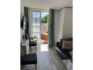 a living room with a couch and a table at Koje in Sankt Peter-Ording