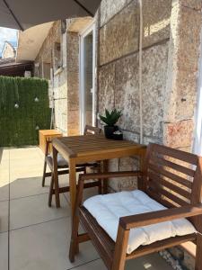 a wooden table and chairs on a patio at Holiday Apartment ORA in Balchik