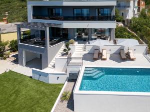 an aerial view of a house with a swimming pool at Villa Providenca - Makarska Exklusiv in Tučepi