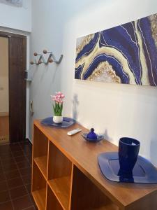 a wooden desk with a vase of flowers on it at Casa Sofia in Villasimius