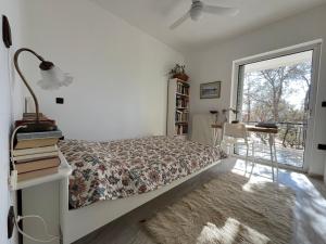 ein Schlafzimmer mit Bett, Schreibtisch und Fenster in der Unterkunft Seaview Haven in Kap Sounion