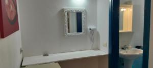 a bathroom with a sink and a mirror on the wall at Canova Apartment in Santa Maria