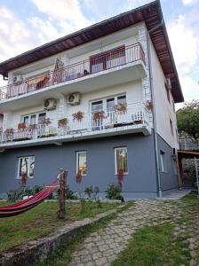 a building with balconies on the side of it at Kavkaz Apartment in Sarajevo
