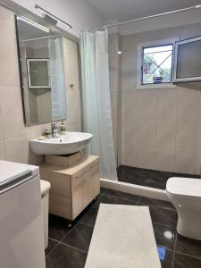 a bathroom with a sink and a toilet at Ktima Lena in Órmos +26 photos