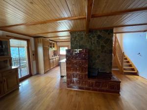 a large kitchen with wooden floors and a wooden ceiling at Sedmakovo - Počitniška hiša v naravi - Ljubno ob Savinji in Ljubno