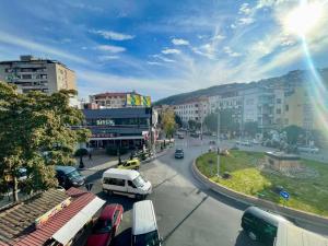 a city with cars parked on a street with buildings at Miya Apartment in Veles