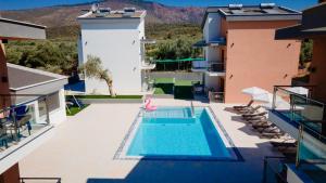 an image of a swimming pool on the roof of a house at Sotiris Luxury Villas in Limenaria