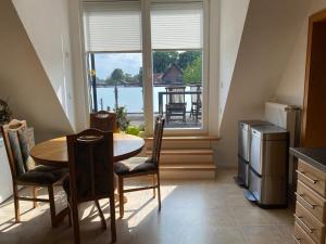 a kitchen with a table and chairs and a window at Gemütliche Wohnung in Xanten
