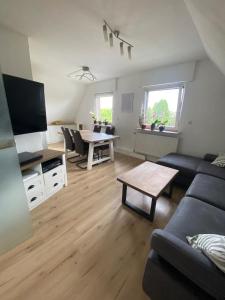 a living room with a couch and a table at Gemütliche Wohnung in Xanten