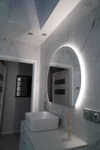 a white bathroom with a sink and a mirror at Mieszkanie w centrum Szczecina in Szczecin +33 photos