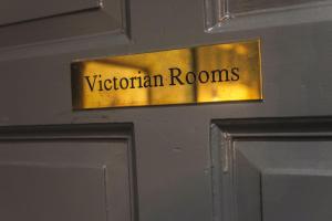 a metal door sign that reads victorian rooms at The Victorian Suite in Marske