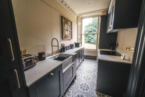 a kitchen with a sink and a counter top at The Victorian Suite in Marske