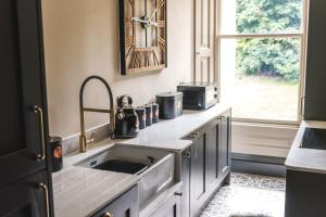 a kitchen with a sink and a window at The Victorian Suite in Marske