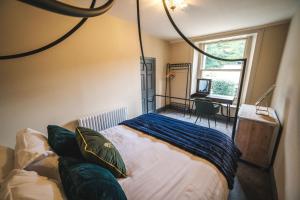 a bedroom with a bed in a room with a window at The Victorian Suite in Marske