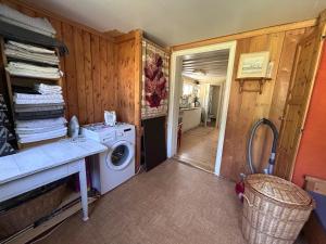 a laundry room with a washing machine and a hallway at Holy Motors camp in Kvikkjokks Kapell