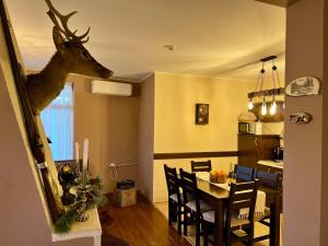 a dining room with a deer head on the wall at Chalet Hamars - Highland Haven in Razlog