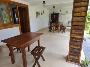 a dining room with a wooden table and chairs at Hotel Serugahawatta in Wellawaya