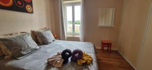 a bedroom with a bed with towels on it at Villa Zelly in Sancergues +20 photos