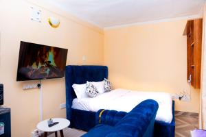 a living room with a bed and a couch at Marie's Studios Naivasha in Naivasha