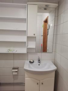 a bathroom with a white sink and a mirror at The White House in Kavadarci