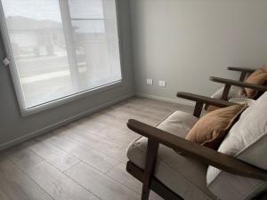 een woonkamer met een raam en een bank bij J&R Home, A Gippsland Getaway in Jeeralang Junction