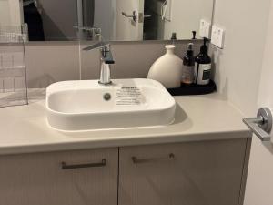 een badkamermeubel met een wastafel en flessen wijn bij J&R Home, A Gippsland Getaway in Jeeralang Junction