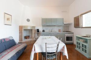 a kitchen with a table and a couch in a room at Casa Domitia in Latiano