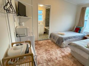 a small room with a bed and a mirror at Tirau Motor Inn in Tirau