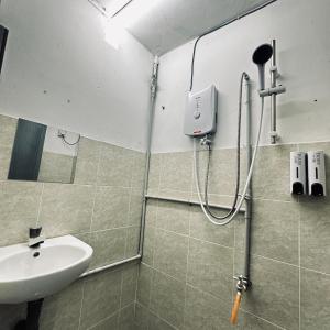 a bathroom with a sink and a shower at Hey Rest Up with shared bathroom in Ipoh +17 photos