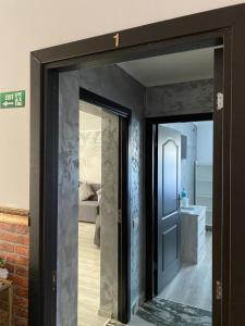 a doorway to a bathroom with a mirror at Casa Ratiu Apartamente 3 stele Airport Bucharest Therme Bucharest in Baloteşti