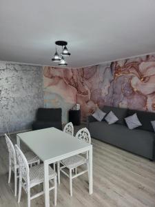 a living room with a white table and chairs at Casa Ratiu Apartamente 3 stele Airport Bucharest Therme Bucharest in Baloteşti