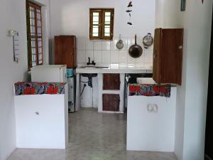 a kitchen with a sink and a counter top at Jambiani Holiday Villa in Jambiani